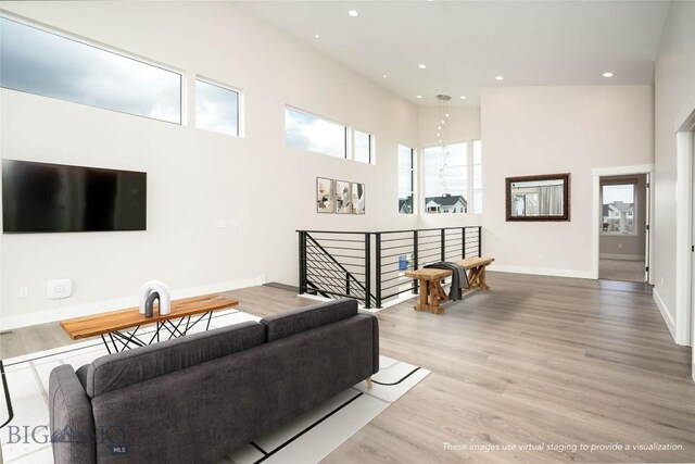 1610 Windrow Dr, Bozeman, MT 59718 - living area with a high ceiling, wood finished floors, recessed lighting, and baseboards