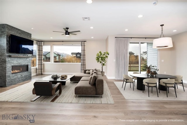 1610 Windrow Dr, Bozeman, MT 59718 - living room with a fireplace, wood finished floors, healthy amount of natural light, baseboards, and recessed lighting