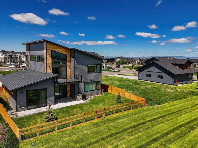 1610 Windrow Dr, Bozeman, MT 59718 - rear view of property featuring a residential view, a balcony, a standing seam roof, metal roof, and a patio