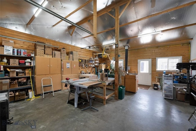 basement featuring a workshop area and wood walls