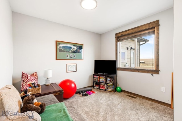 rec room with baseboards, visible vents, and carpet