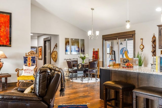 interior space featuring lofted ceiling, an inviting chandelier, and dark wood-type flooring