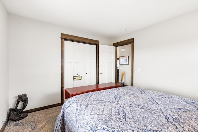 carpeted bedroom featuring baseboards and a closet