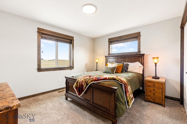 bedroom with carpet and baseboards