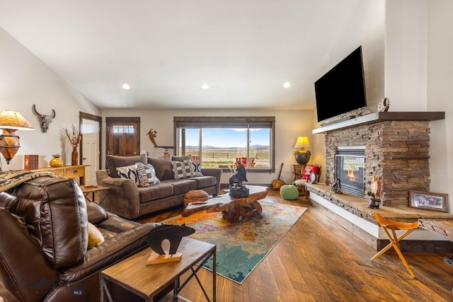 living area featuring a fireplace, wood finished floors, and recessed lighting