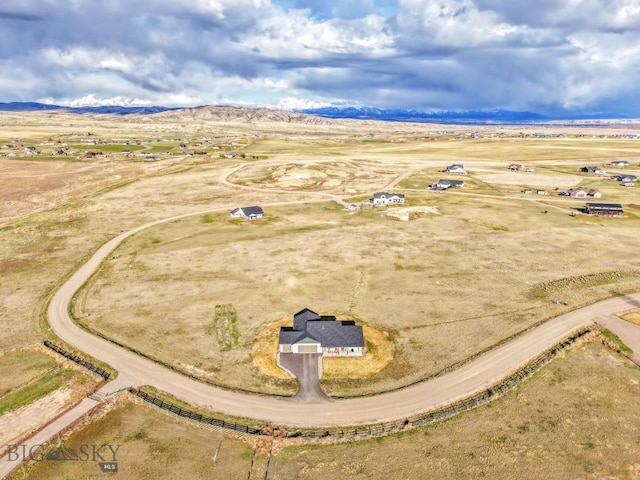 birds eye view of property featuring a mountain view and a rural view
