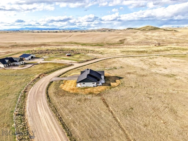 drone / aerial view featuring a rural view and a mountain view