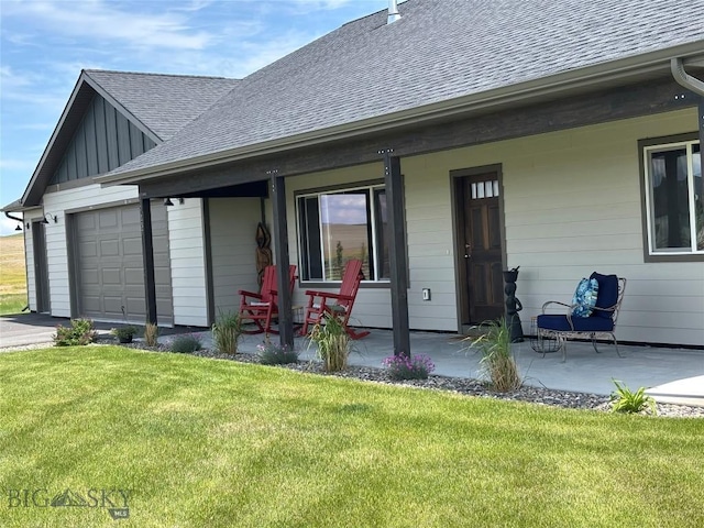 137 Horizon Loop, Three Forks, MT 59752 - back of house with roof with shingles, a yard, an attached garage, and board and batten siding