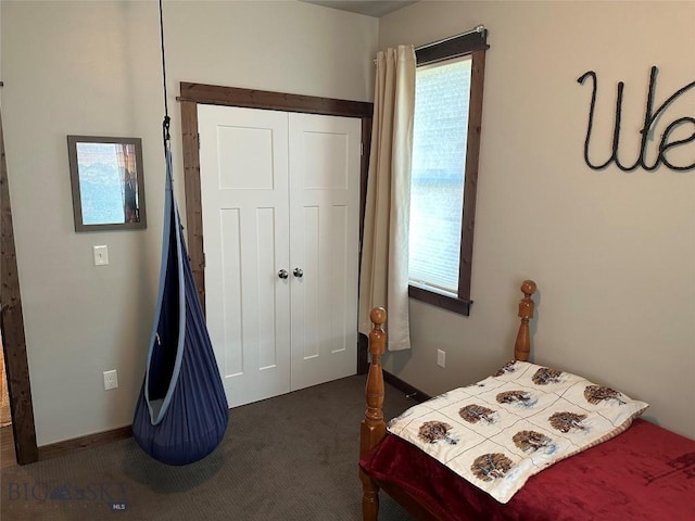 bedroom featuring dark carpet and a closet