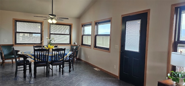 719 Jefferson St, Ennis, MT 59729 - dining area with lofted ceiling, healthy amount of natural light, ceiling fan, and dark tile patterned flooring