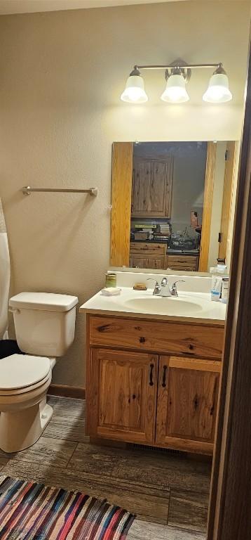 719 Jefferson St, Ennis, MT 59729 - half bathroom featuring vanity and wood finished floors