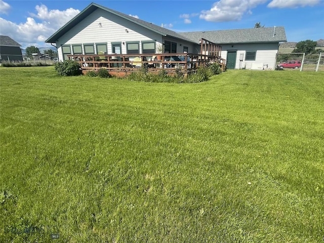 719 Jefferson St, Ennis, MT 59729 - back of house with a deck and a lawn