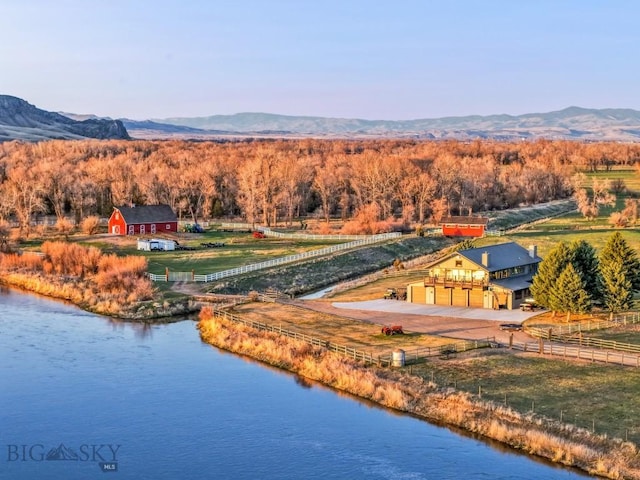 bird's eye view with a rural view, a forest view, and a water and mountain view