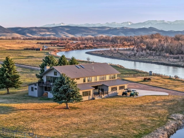 drone / aerial view featuring a rural view and a water and mountain view