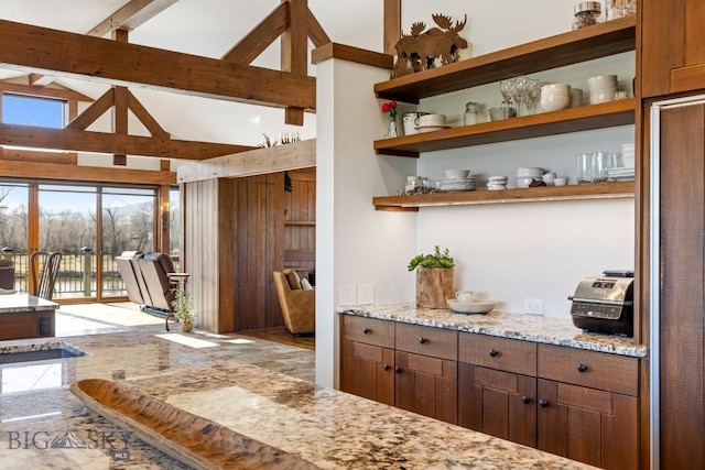 bar featuring beamed ceiling and high vaulted ceiling