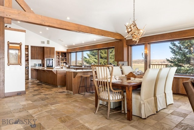 dining room featuring recessed lighting, stone finish flooring, lofted ceiling with beams, and an inviting chandelier