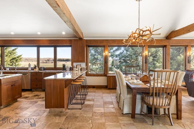 dining room featuring lofted ceiling with beams, an inviting chandelier, stone finish floor, and recessed lighting