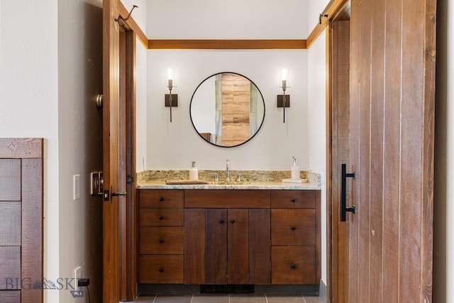 bathroom featuring tile patterned flooring and vanity