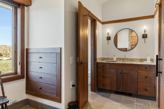 bathroom featuring tile patterned flooring, toilet, and vanity