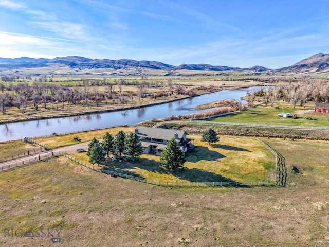 birds eye view of property featuring a water and mountain view and a rural view