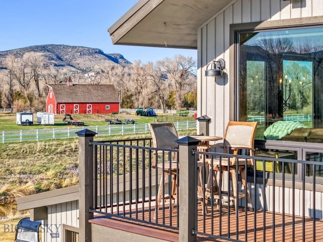 view of patio with fence and a mountain view