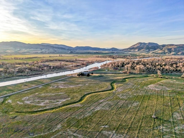 birds eye view of property with a water and mountain view