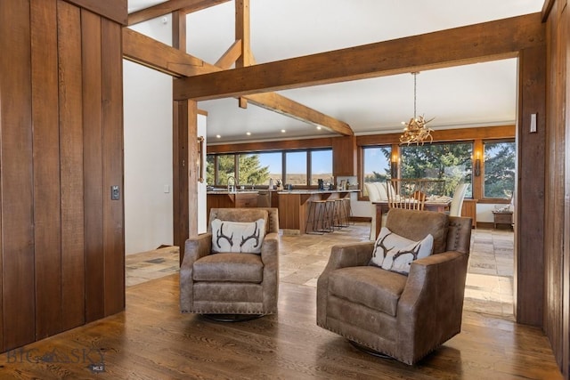 sitting room featuring a chandelier, wood finished floors, beamed ceiling, and recessed lighting