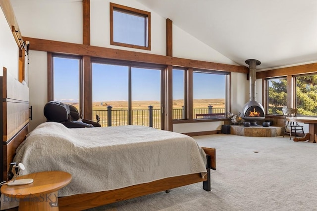 bedroom featuring carpet, a wood stove, and high vaulted ceiling