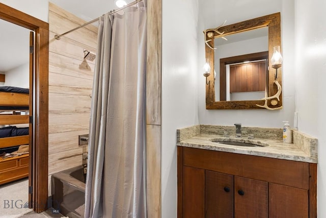 bathroom with ensuite bathroom, vanity, and shower / tub combo with curtain