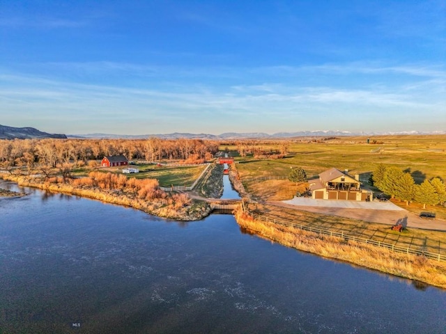 drone / aerial view with a water and mountain view