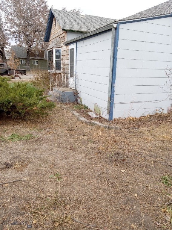 618 Washington St, Miles City, MT 59301 - view of side of home with roof with shingles