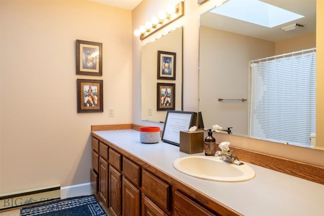 full bath featuring a skylight, a baseboard heating unit, vanity, baseboards, and a shower with shower curtain
