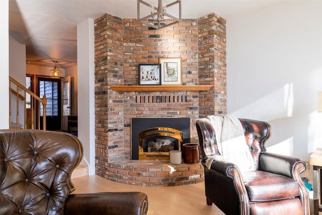 interior space featuring stairway and a brick fireplace