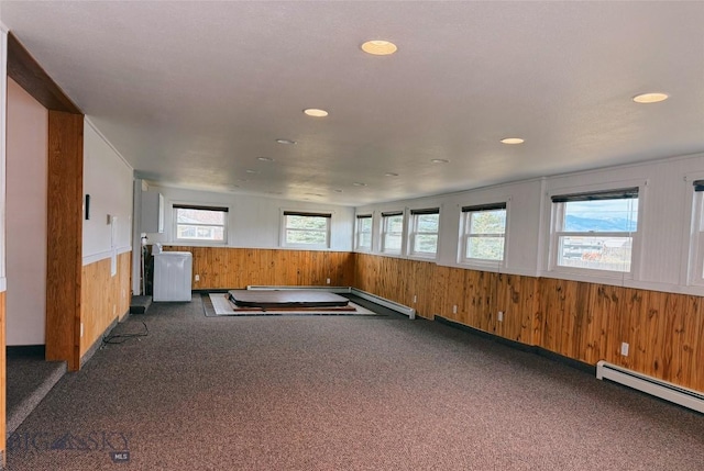 509 1st E, Whitehall, MT 59759 - unfurnished room with carpet flooring, wooden walls, a baseboard radiator, a wainscoted wall, and recessed lighting