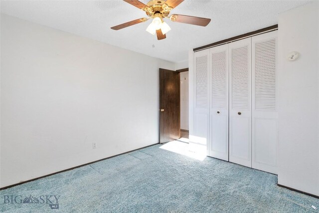 509 1st E, Whitehall, MT 59759 - unfurnished bedroom with carpet floors, a closet, and a ceiling fan