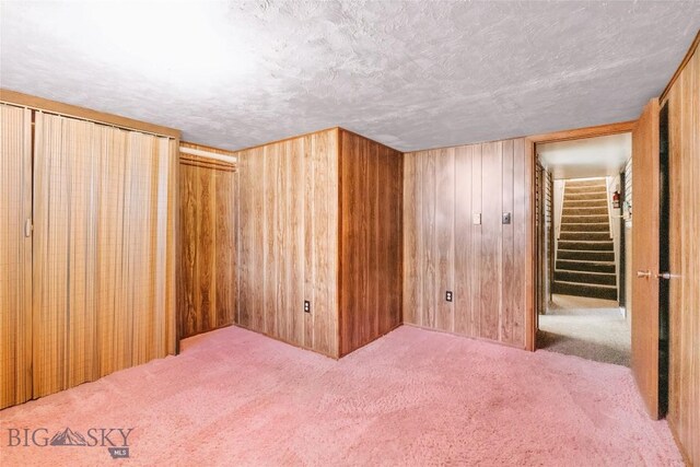 509 1st E, Whitehall, MT 59759 - carpeted bedroom with wood walls and a textured ceiling