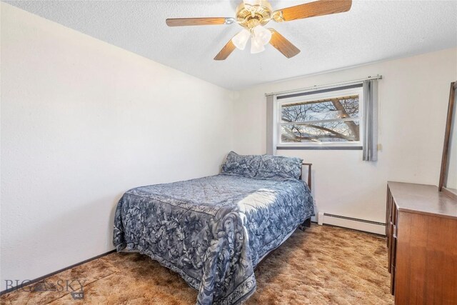 509 1st E, Whitehall, MT 59759 - bedroom with baseboard heating, carpet flooring, a textured ceiling, and a ceiling fan