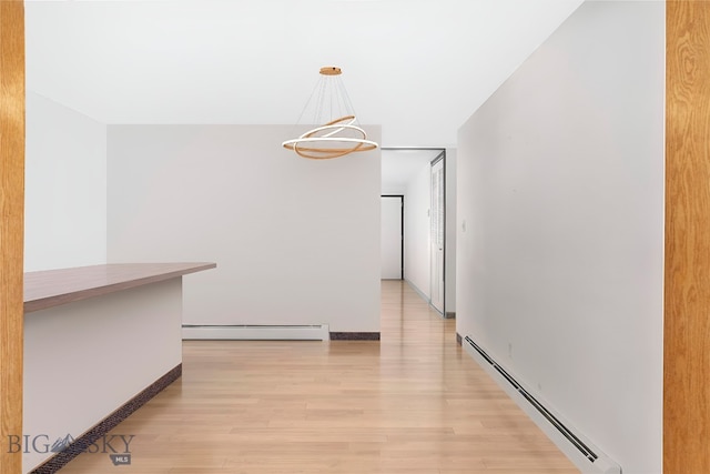 509 1st E, Whitehall, MT 59759 - corridor featuring a baseboard radiator, light wood-style flooring, and a chandelier