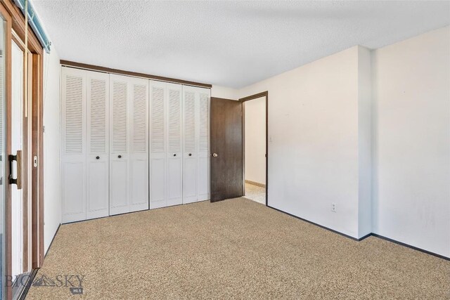 509 1st E, Whitehall, MT 59759 - unfurnished bedroom with carpet floors, a closet, and a textured ceiling