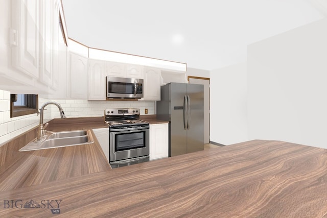 509 1st E, Whitehall, MT 59759 - kitchen with stainless steel appliances, backsplash, and white cabinets