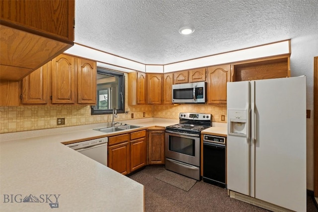 509 1st E, Whitehall, MT 59759 - kitchen with stainless steel appliances, light countertops, a textured ceiling, brown cabinetry, and decorative backsplash