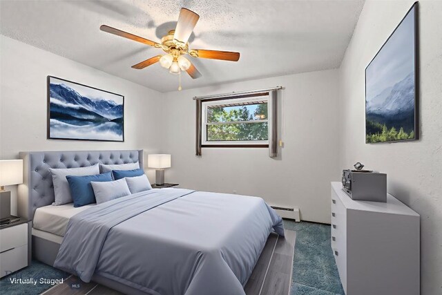 509 1st E, Whitehall, MT 59759 - carpeted bedroom featuring a baseboard heating unit and a ceiling fan