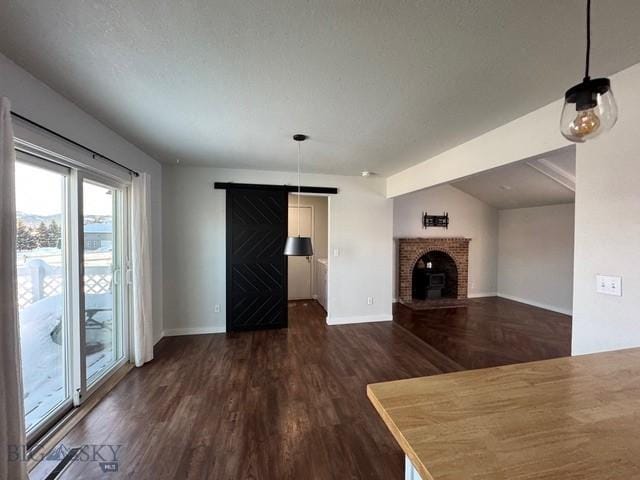 unfurnished living room with baseboards and dark wood finished floors