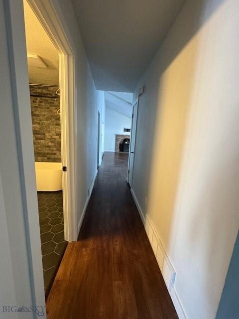 hallway featuring dark wood finished floors and visible vents
