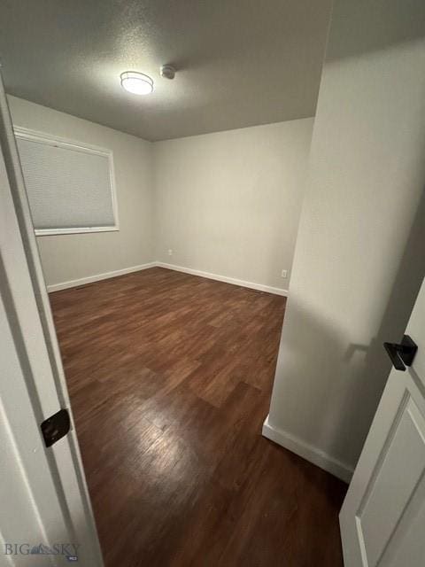 1421 Bluebird Ln, Bozeman, MT 59715 - spare room featuring dark wood finished floors and baseboards