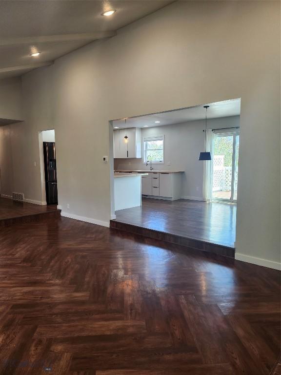 1421 Bluebird Ln, Bozeman, MT 59715 - unfurnished living room featuring a towering ceiling and a sink