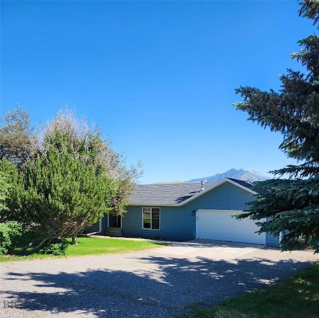 1421 Bluebird Ln, Bozeman, MT 59715 - ranch-style house featuring driveway, an attached garage, and a mountain view