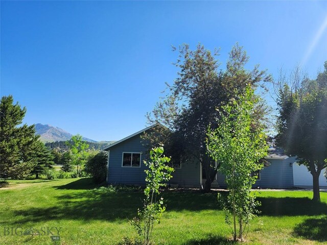 1421 Bluebird Ln, Bozeman, MT 59715 - view of home's exterior featuring a yard and a mountain view