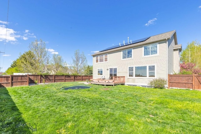 3609 Fieldstone W, Bozeman, MT 59715 - rear view of property with a fenced backyard, a wooden deck, and solar panels