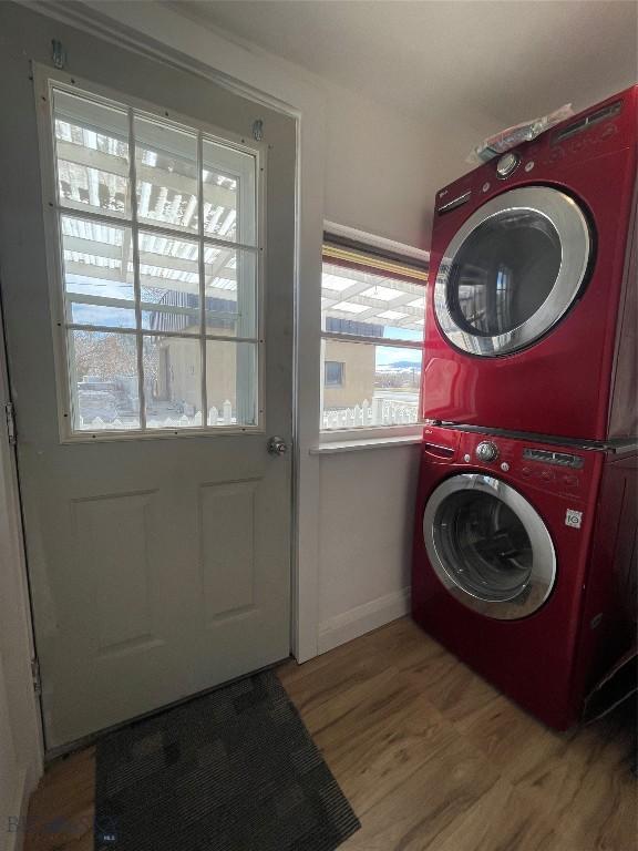 307 W Legion St, Whitehall, MT 59759 - laundry area with stacked washer and dryer, baseboards, wood finished floors, and laundry area
